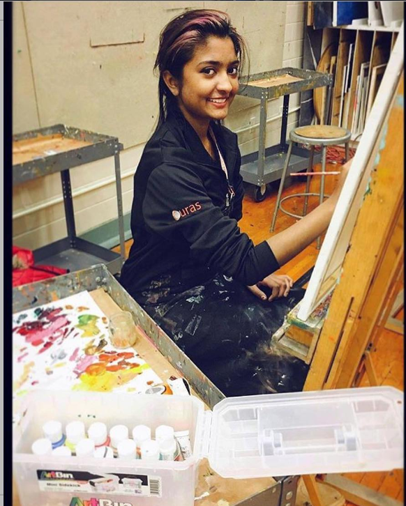 Artist at the easel working on a commissioned piece