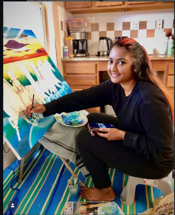 Artist painting a sunrise horse canvas at home