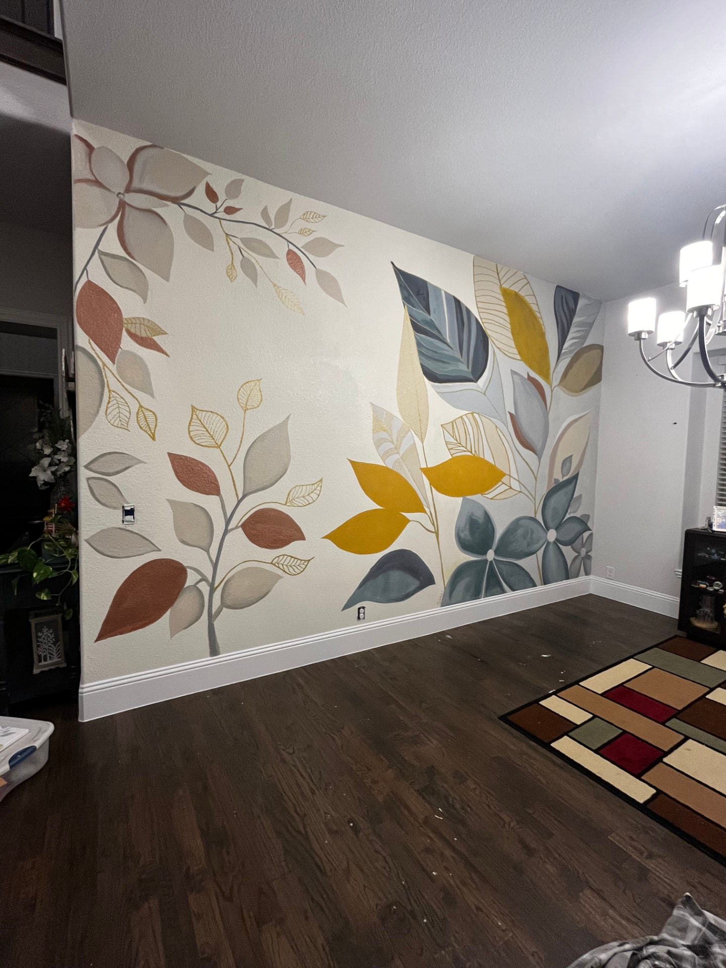 Botanical leaf and flower mural painted across a dining room accent wall